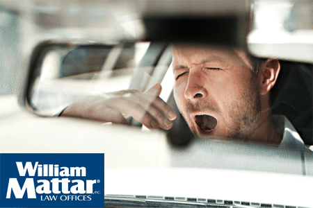 Man yawning while driving