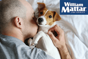 Man embracing pet dog for comfort