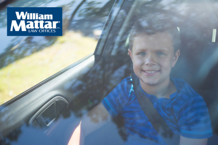 Child sitting in front seat of car