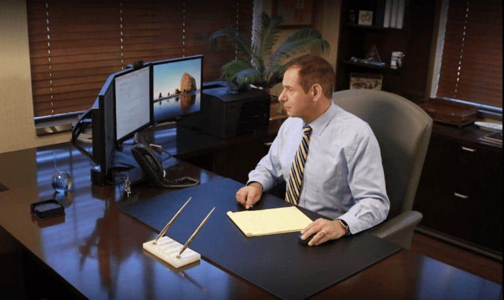 William Mattar sitting at his office looking into his computer screen