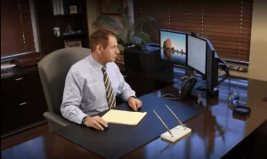 william mattar sitting in his office looking at computer screens