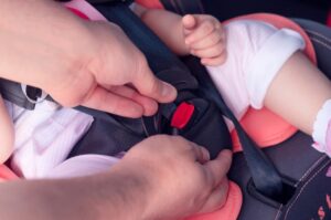 The process of fastening seat belts on a child restraint seat in the car. Safety for children, transport safety