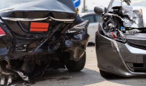 Car accident involving two vehicles on the road. Car insurance for automobiles. Car crash on the street. Vehicles involved in a road accident.