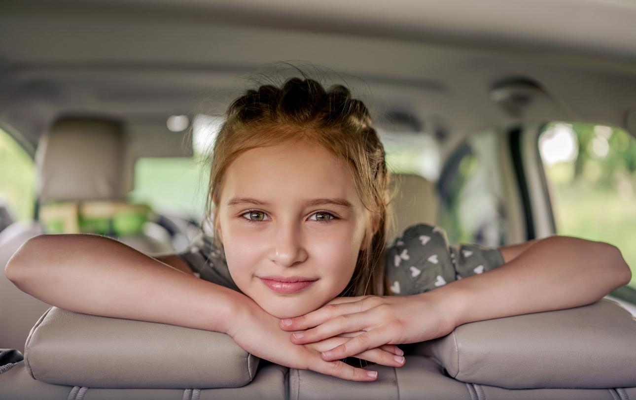 Preteen girl with car at the nature