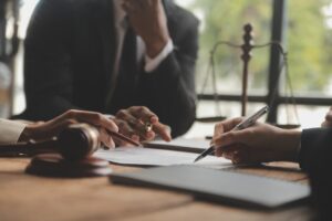 Businesswoman consulting with a male lawyer or judge during a team meeting. The concept of law and legal services is highlighted.