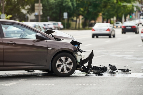 Front-end damaged car after a collision at an intersection, illustrating crash severity for a New York car accident lawyer case.