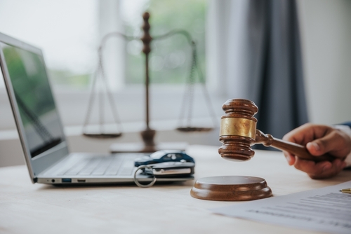 Judge’s gavel beside a laptop and legal documents, representing legal action and claims handled by a New York car accident lawyer.