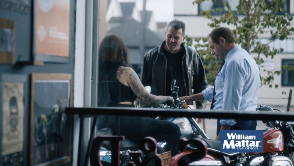 William Mattar talking with motorcycle rider