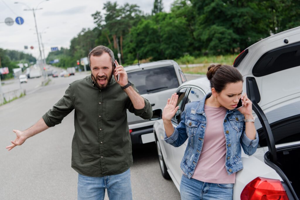 A man and women arguing over who is at fault in car accident